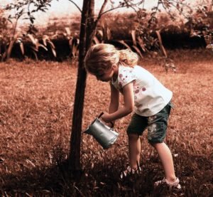 girl wattering a tree #5SLL #5sensesLL #normalisoverrated #homeschool #neurodiversehomeschooling #adhdhomeschooling #specialneedshomeschooling